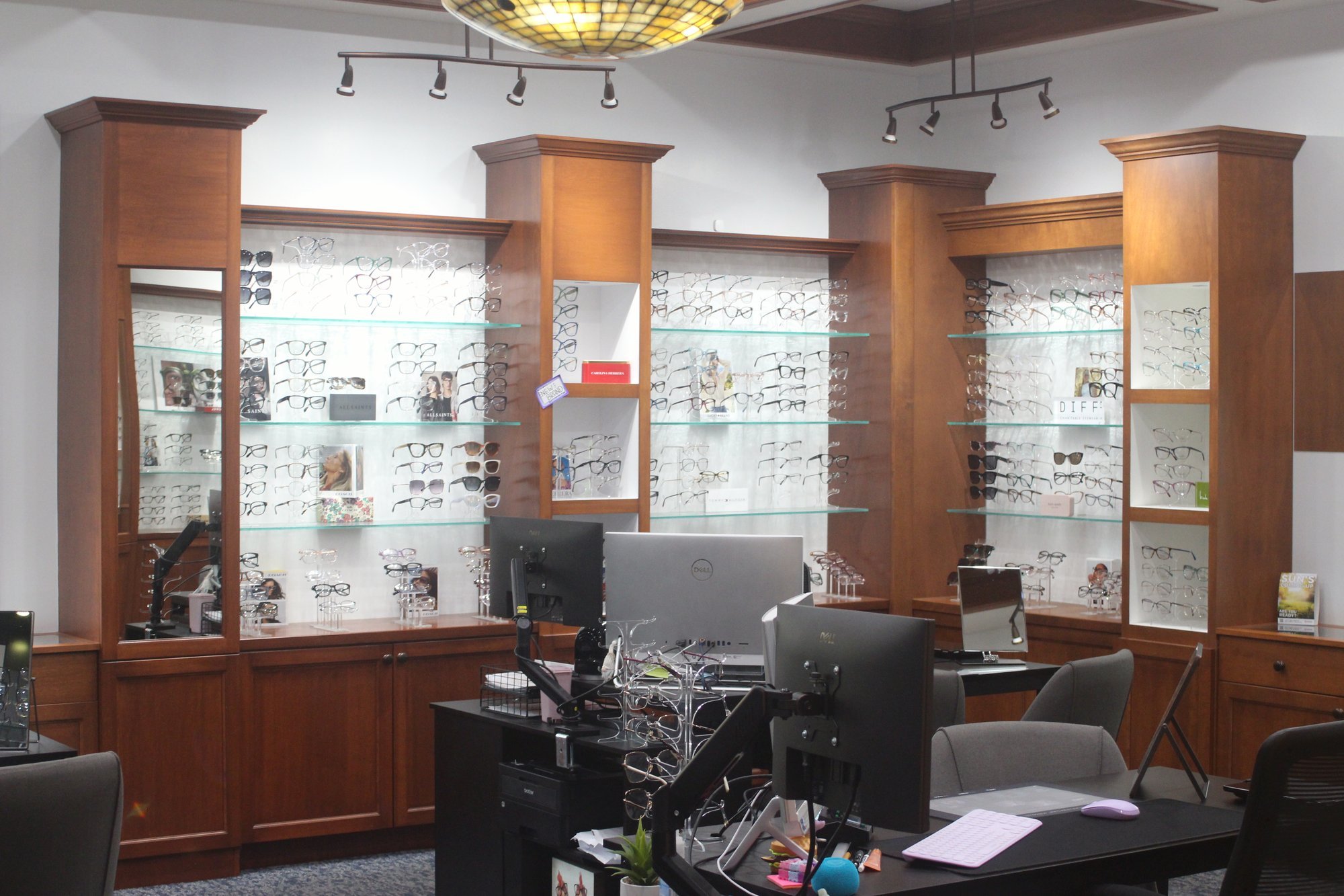 The optical at Central Ohio Vision and Eyecare in New Albany, with wall displays of eyeglass frames and dispensing desks