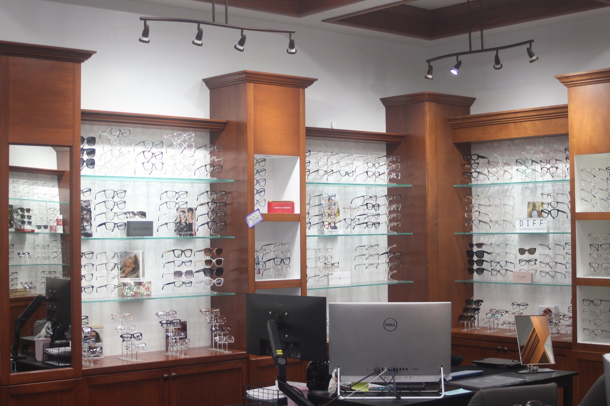 The optical at Central Ohio Vision and Eyecare in New Albany, with frame and sunglass walls surrounding the dispensing desks